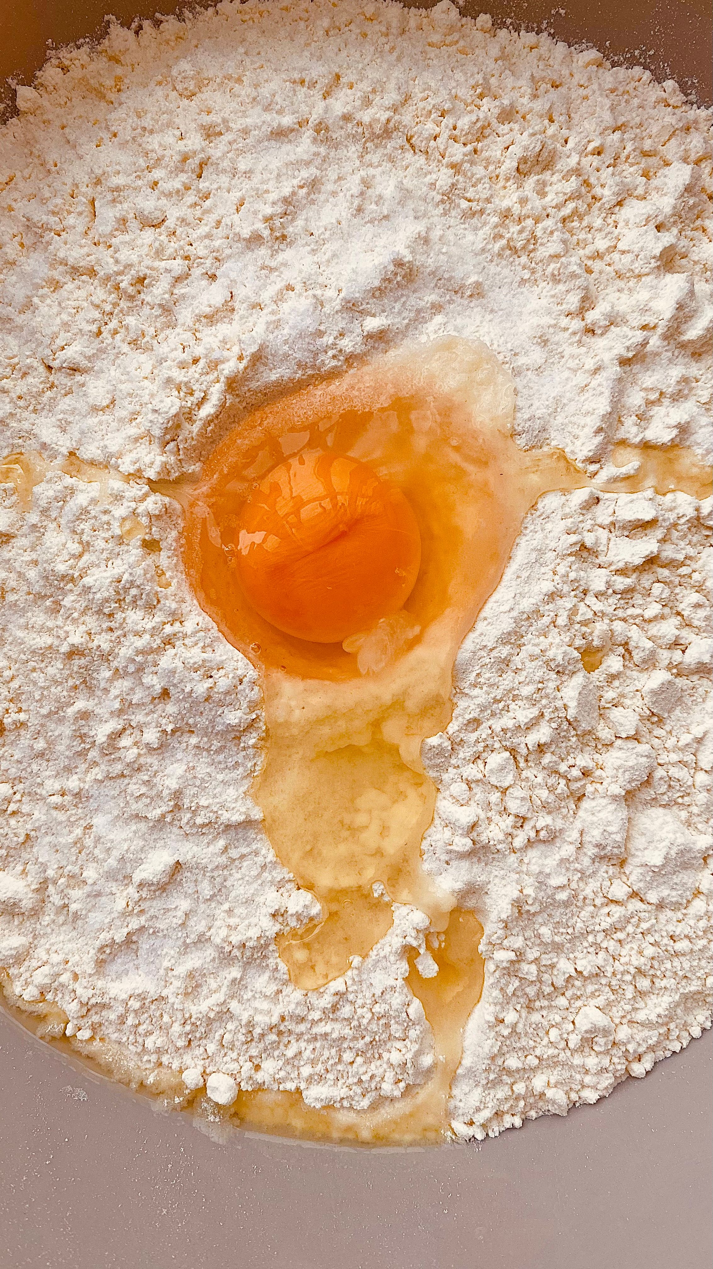 Top view of flour and raw egg mixture ready for baking or cooking preparation.