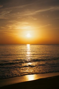 Serene golden sunset over the Mediterranean Sea in Antalya, Türkiye.