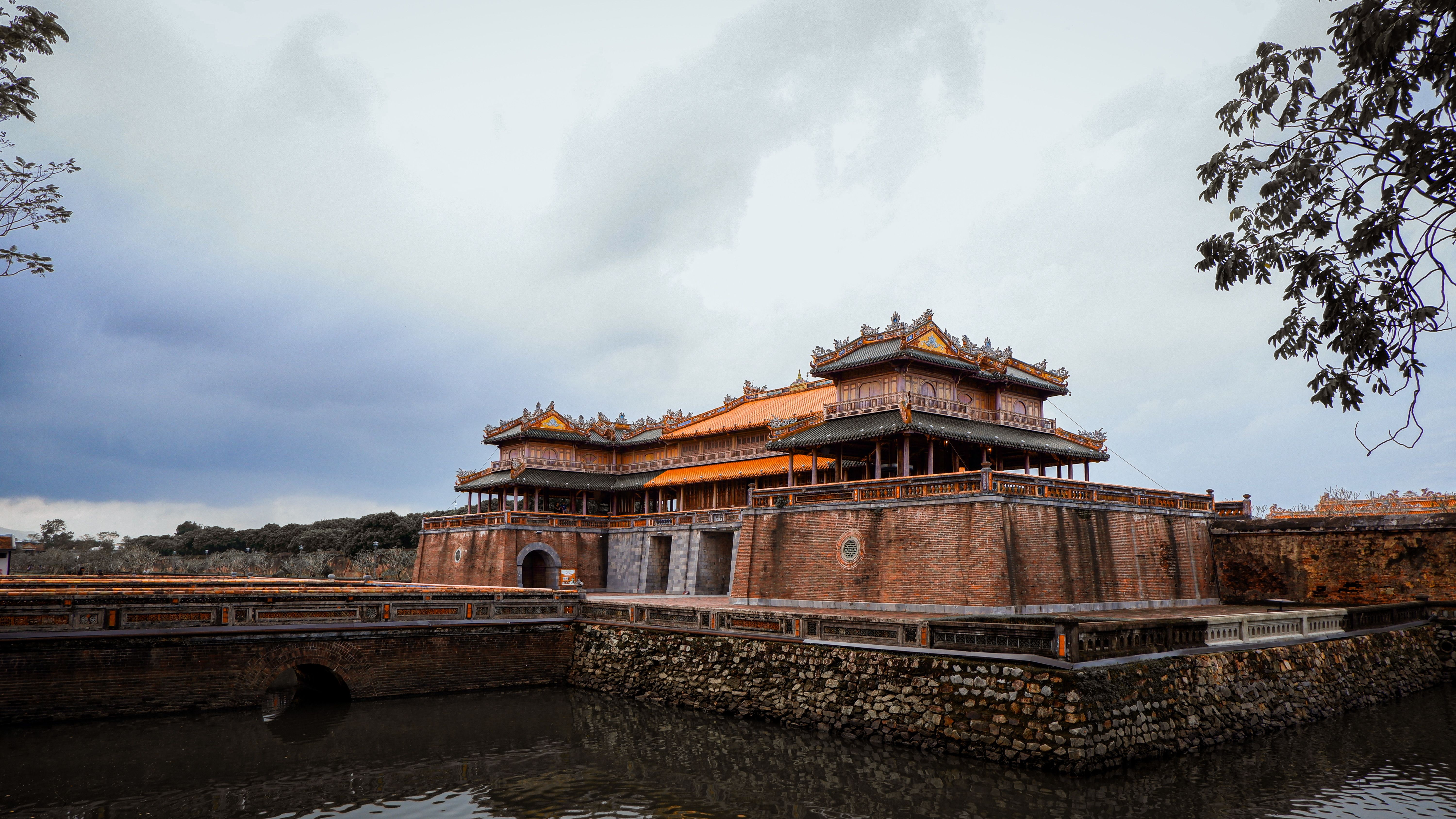 Explore the historic architecture of Hue's Imperial City, Vietnam, with ornate structures and vibrant designs.