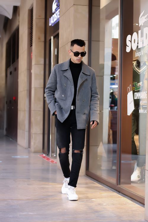 Free Stylish young man in sunglasses walking in Marrakesh mall, Morocco. Stock Photo