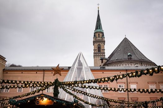 Embrace holiday spirit at a charming Christmas market with historic buildings and festive lights.