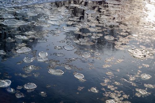 Free Aerial view of a frozen lake with intricate ice patterns reflecting sunlight. Stock Photo