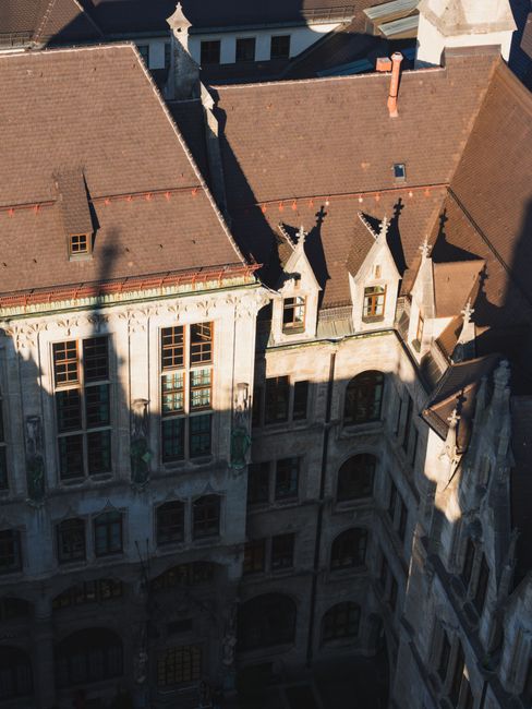 Aerial shot of a historic building in Munich, showcasing gothic architecture and afternoon shadows.