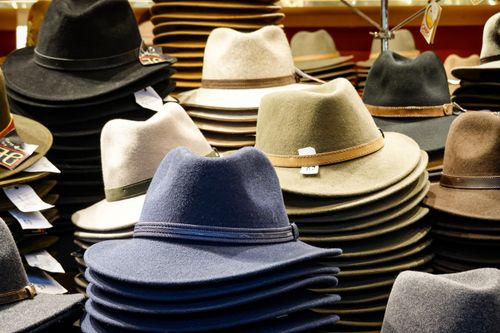 Free Discover piles of stylish fedora hats in various colors in a store display. Stock Photo