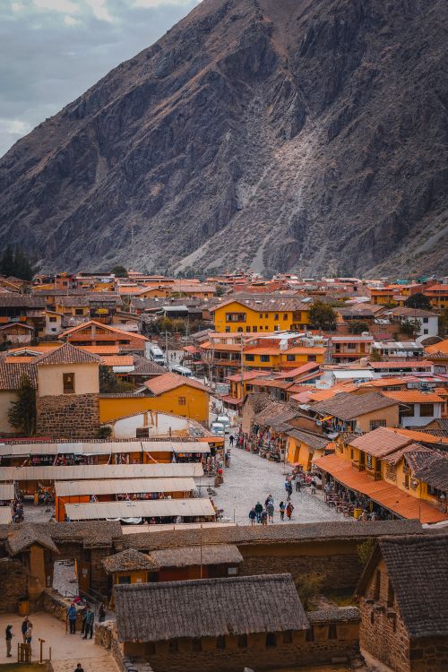 Free Colorful buildings in Ollantaytambo with mountain backdrop in Cusco, Peru. Stock Photo