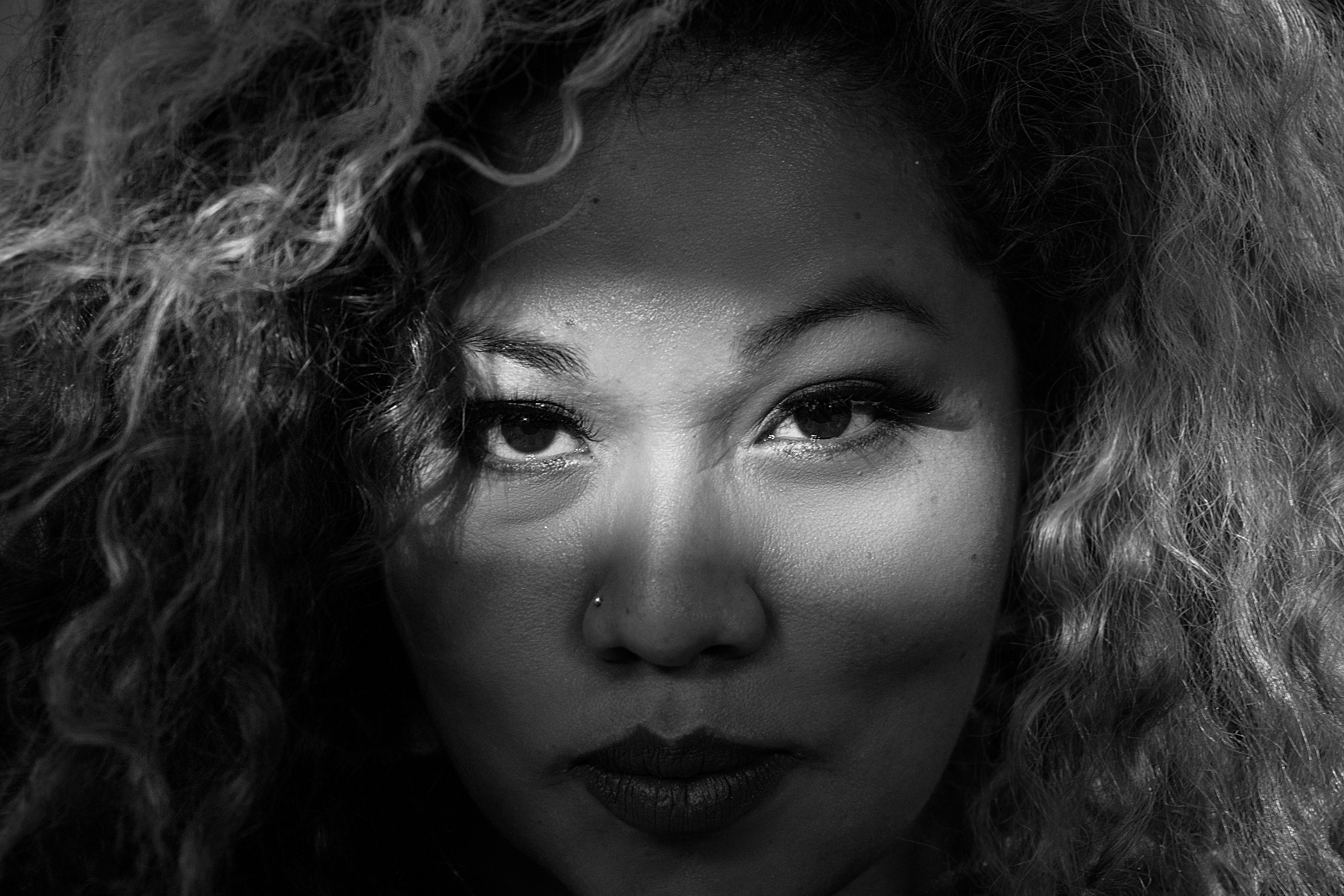 Black and White Portrait of Woman with Curly Hair · Free Stock Photo