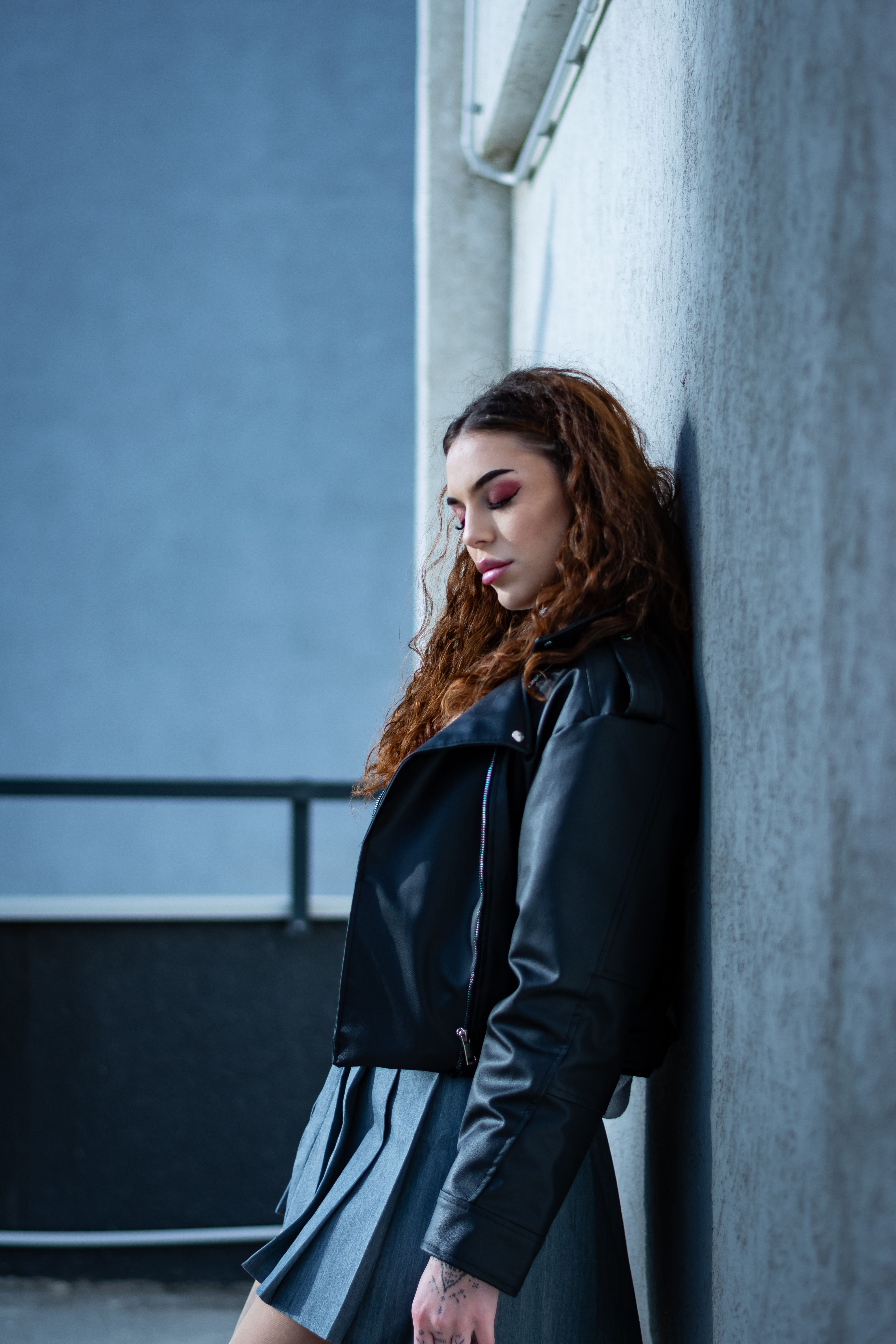 Woman in leather jacket with midi wrap skirt and blouse