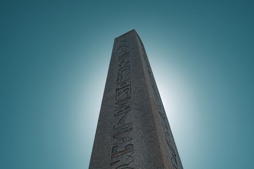 Ancient Theodosius Obelisk against clear blue sky in İstanbul, Türkiye.