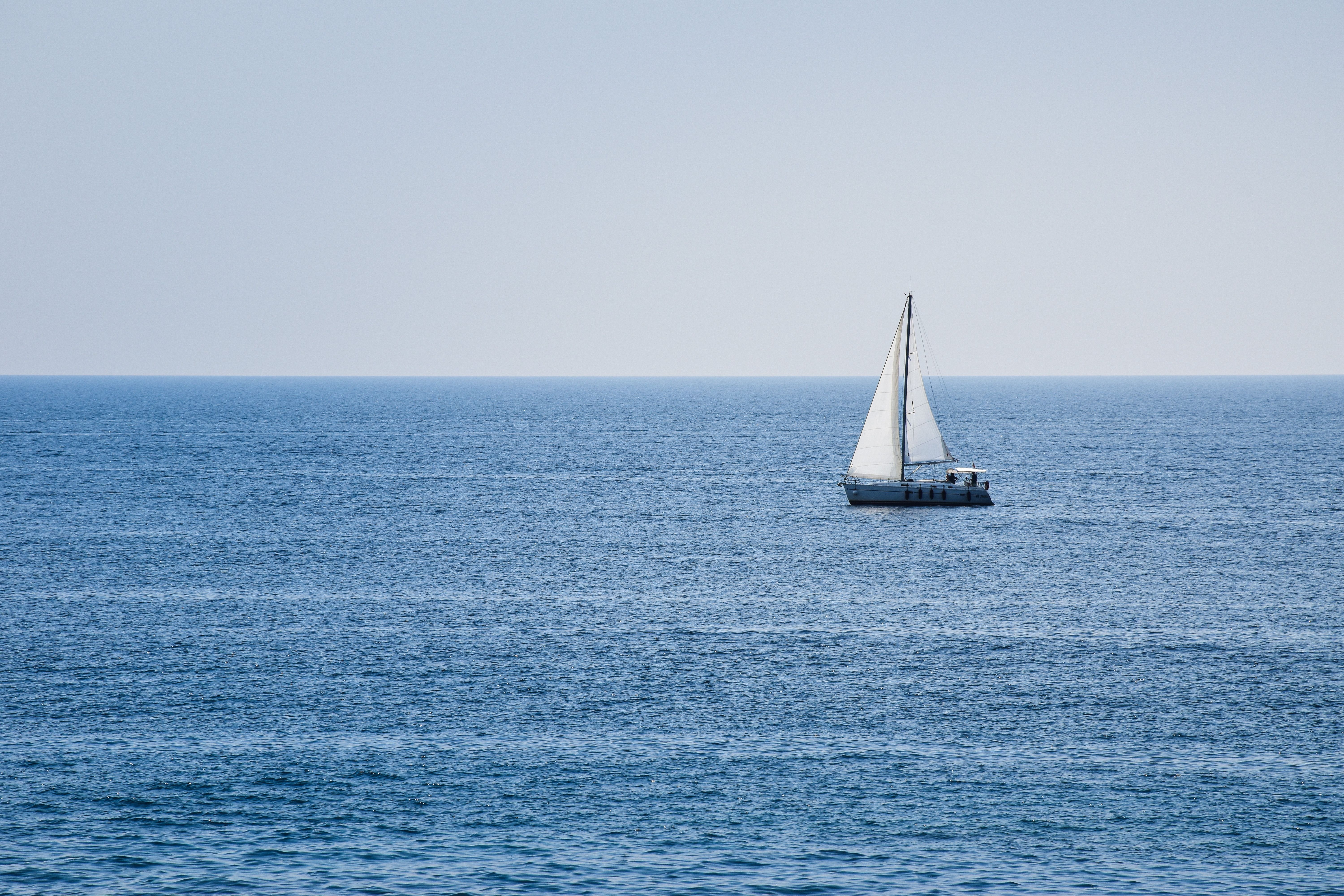 Incredible Gargano from Vieste Yacht Excursion with Aperitif and Skipper Review 2026 - A serene view of a solitary sailboat on the blue Adriatic waters in Apulia, Italy.
