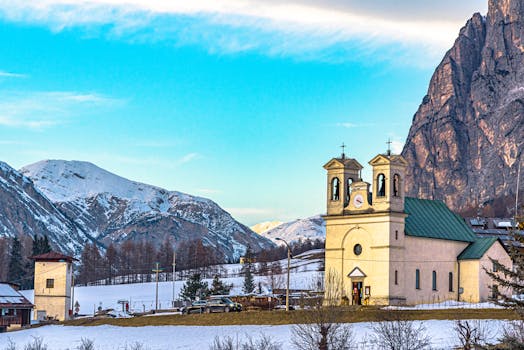Charming church nestled in the snowy Alps of Cortina d'Ampezzo, Italy. Perfect for winter travel imagery.