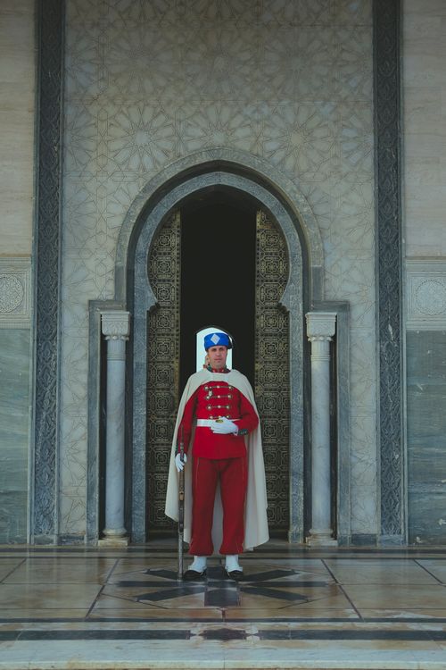 Free A Moroccan guard stands solemnly at the entrance of the Royal Palace in Rabat. Stock Photo