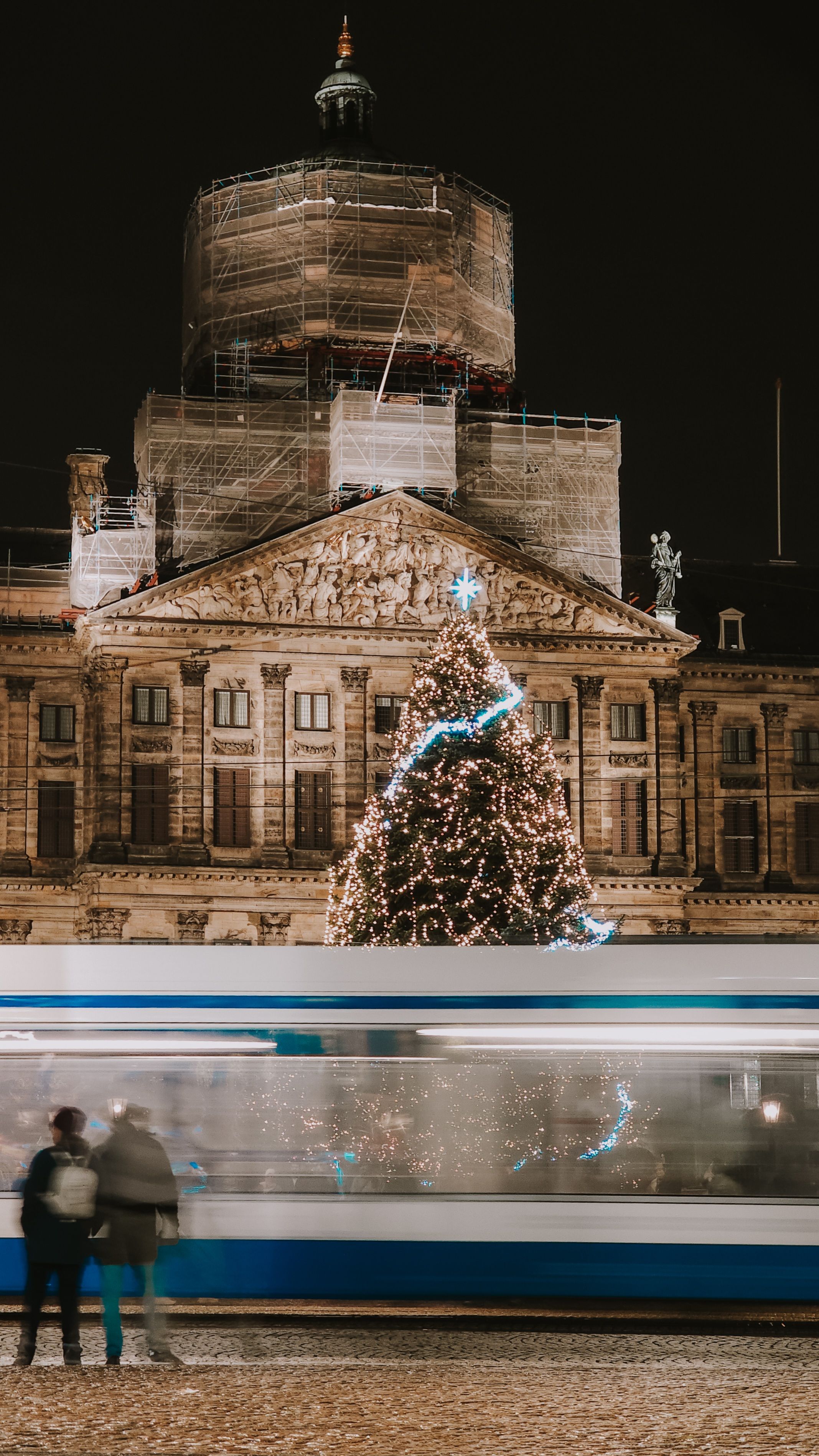 festive night in front of historic building