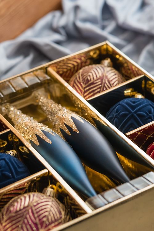 Free A close-up of a luxurious box of Christmas ornaments with rich textures and colors. Stock Photo