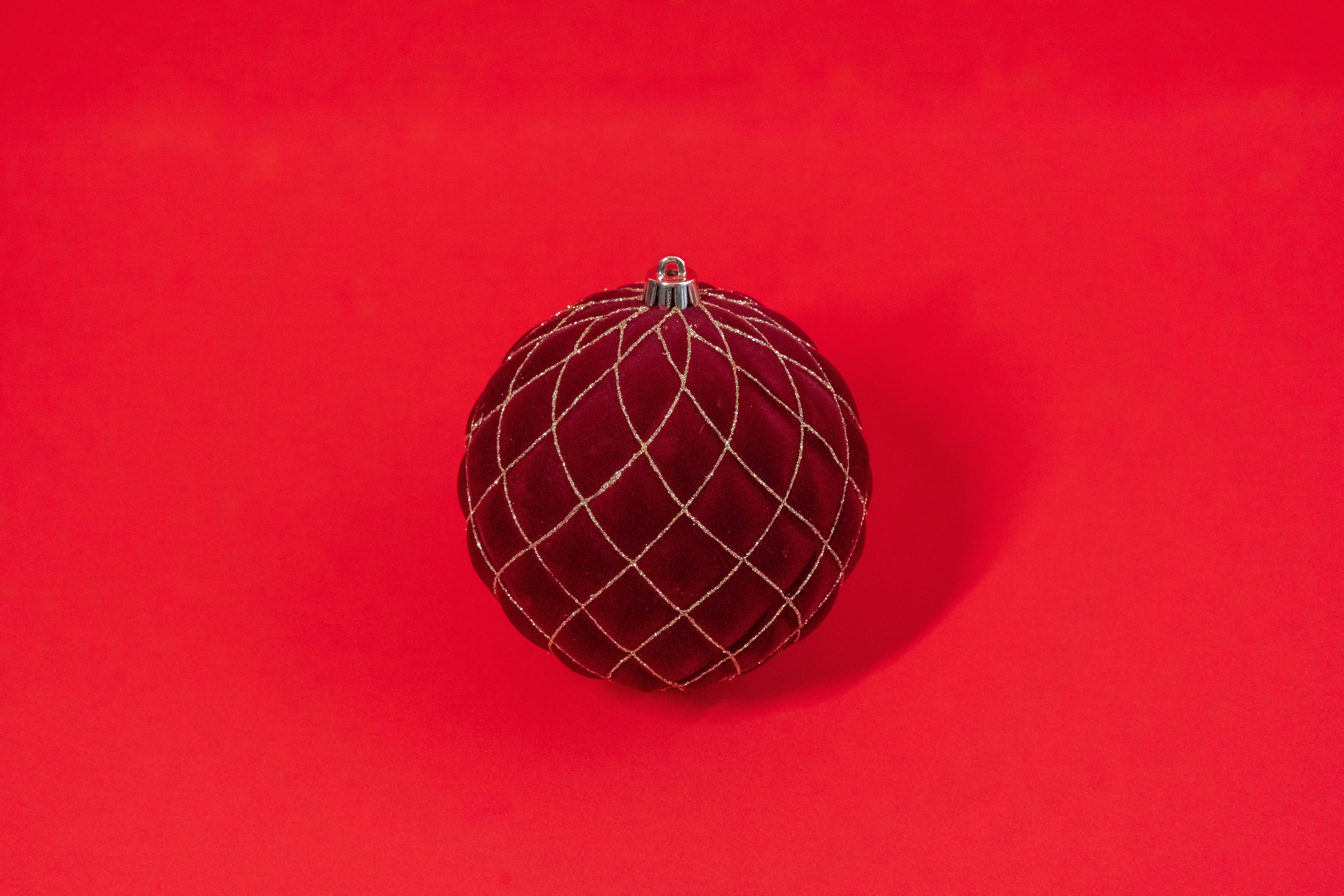 festive velvet christmas ornament on red background