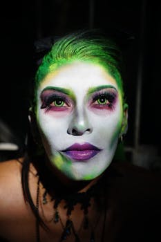 Close-up portrait of a woman with vibrant fantasy makeup, highlighting creativity.