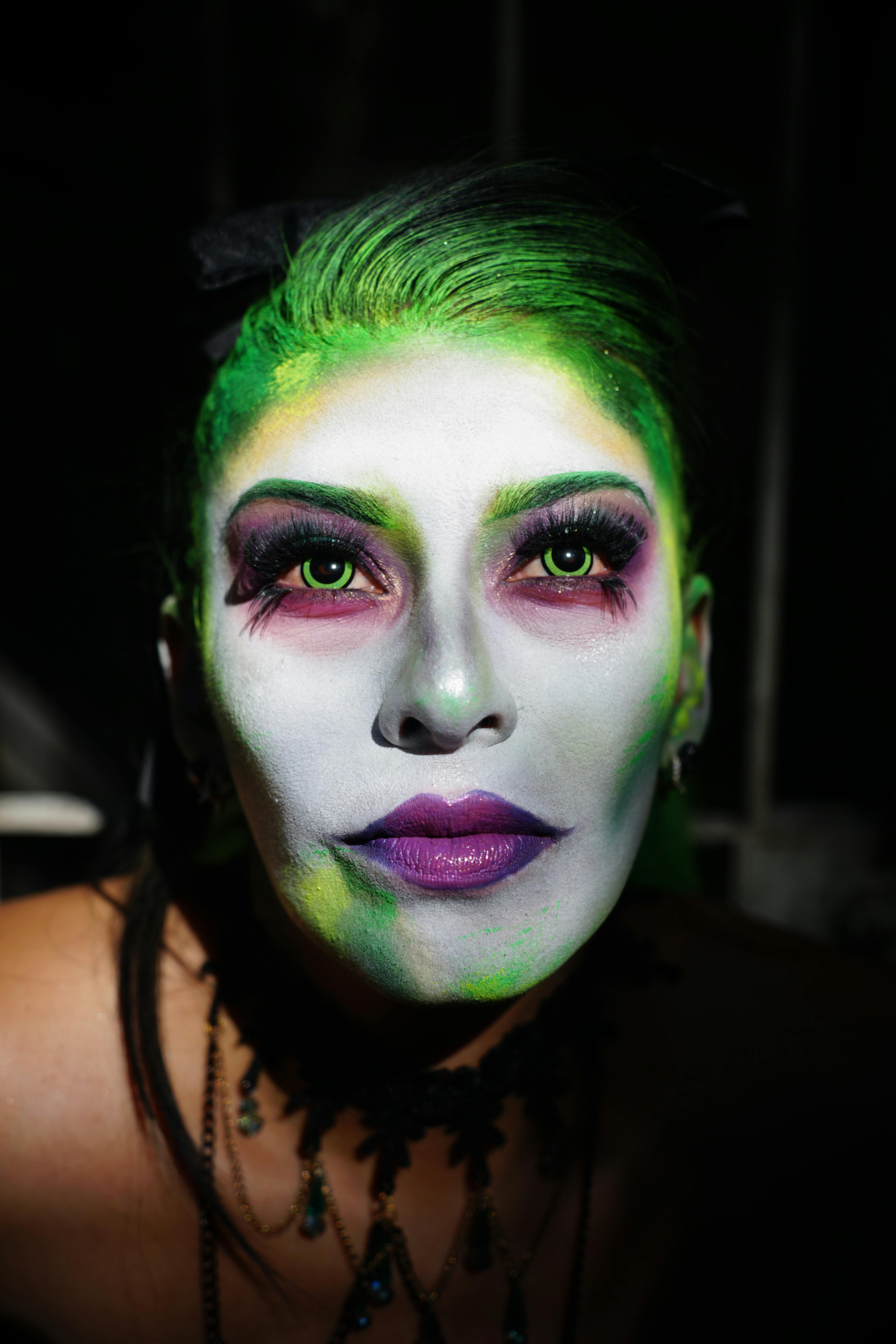 Free Close-up portrait of a woman with vibrant fantasy makeup, highlighting creativity. Stock Photo