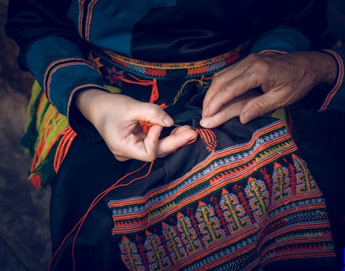 Free Close-up of hands creating traditional embroidery with vibrant colors. Stock Photo