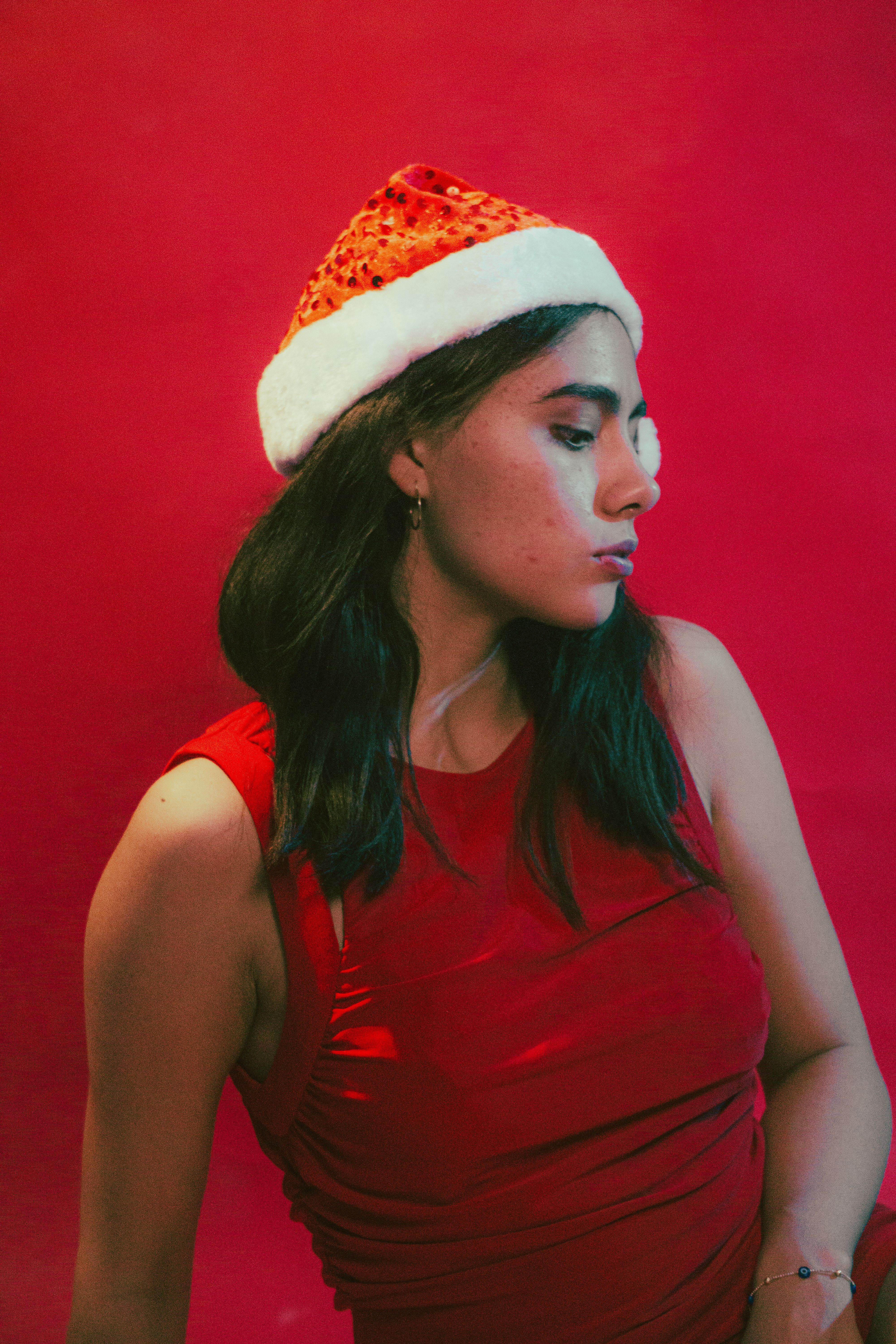 Festive Portrait of Woman in Santa Hat · Free Stock Photo