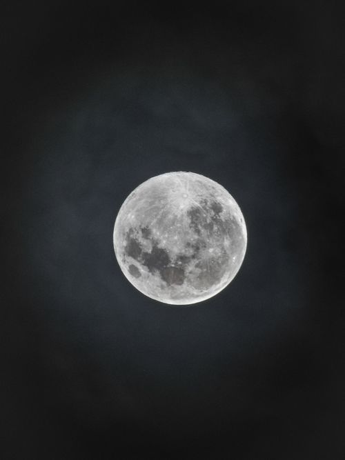 Free Bright full moon against a dark night sky, showcasing lunar details. Stock Photo