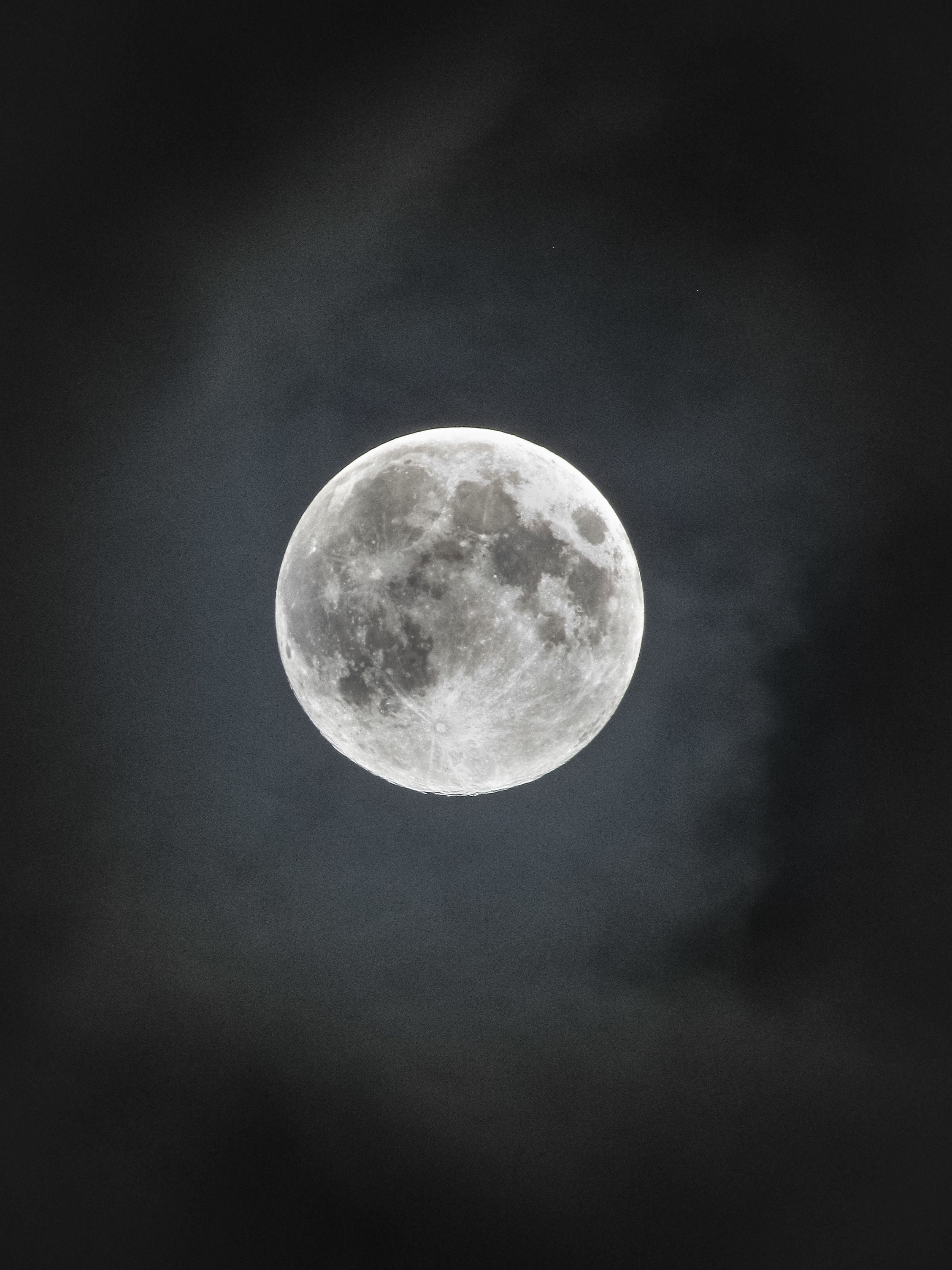Stunning full moon captured in a clear night sky, highlighting lunar surface details.