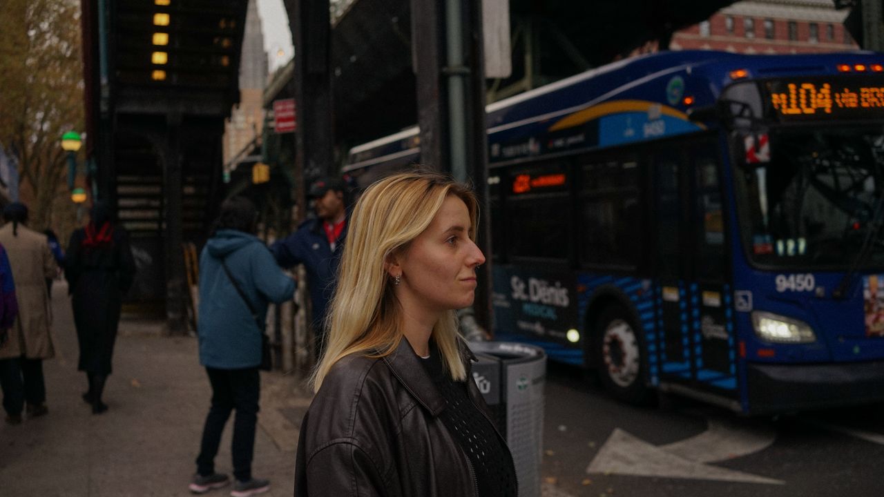 Urban public transportation and commute costs City street with bus pedestrians and elevated transit representing transportation costs in a relocation budget