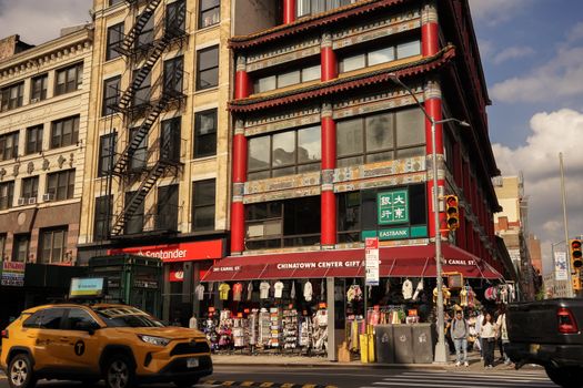 Busy day at Chinatown, New York City, with traditional architecture and bustling street life.
