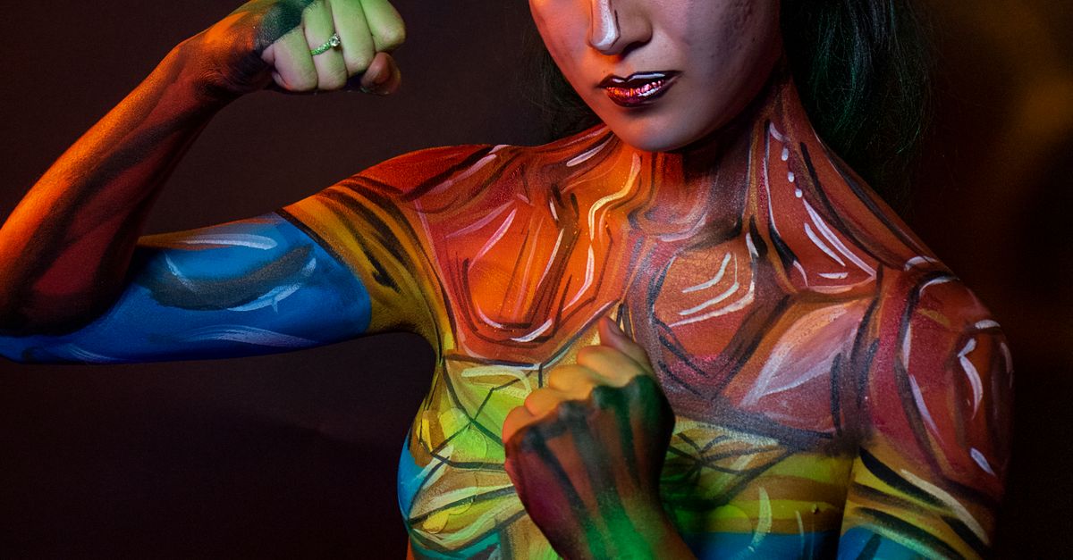Colorful Body Colorful Body Art on Woman Posing Confidently · Free Stock Photo