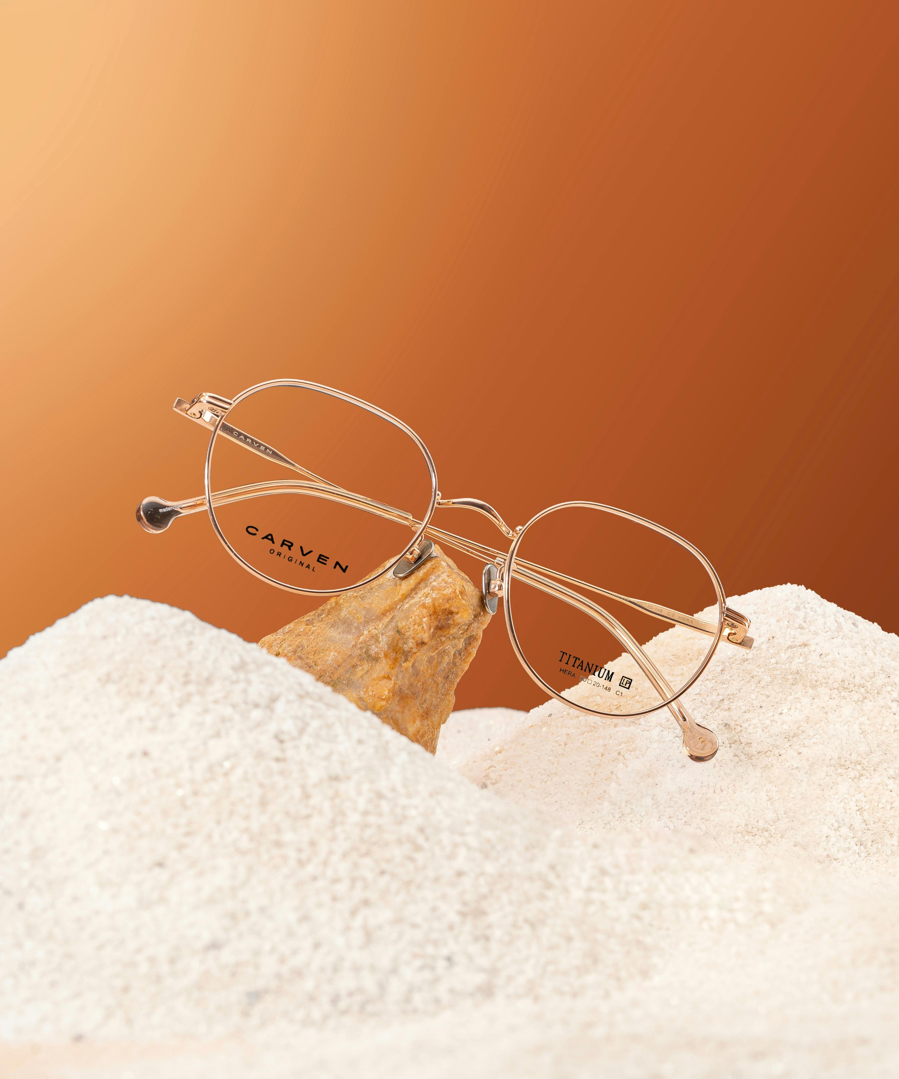 luxury eyewear on sandy beach background