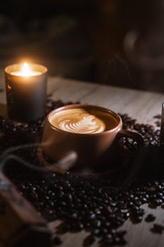 A cozy coffee scene with latte art and candlelight in a warm ambiance.