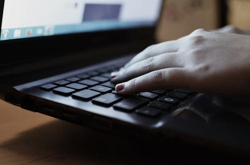 Free Person Using the Black Laptop Computer Stock Photo
