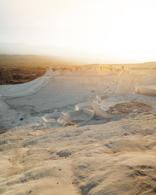 Free Scenic view of Pamukkale's travertine terraces captured in golden sunset light. Stock Photo