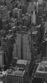 Black and white aerial shot of New York City's iconic skyline featuring the New Yorker Hotel.