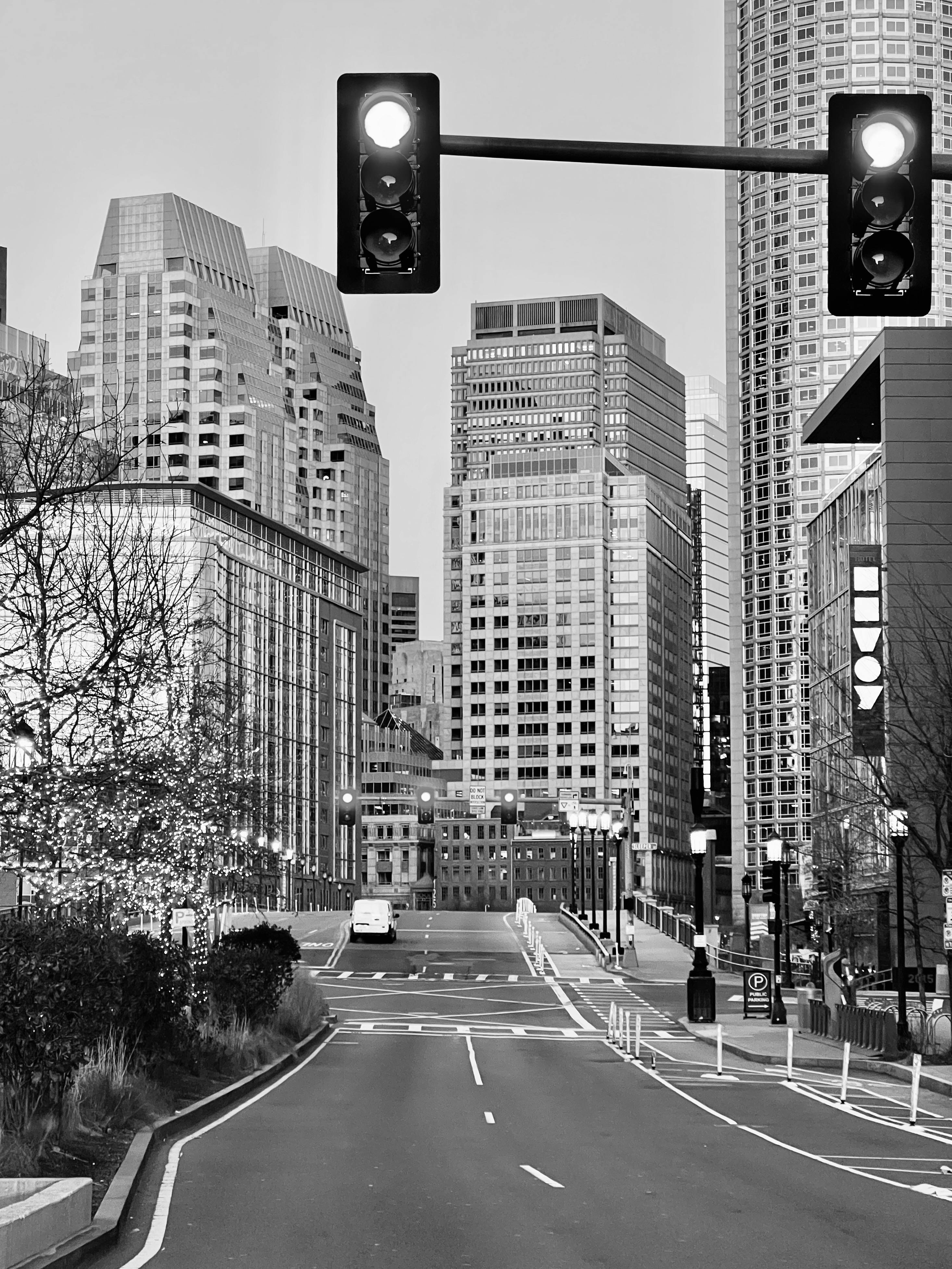 Monochrome cityscape featuring modern skyscrapers and empty streets.