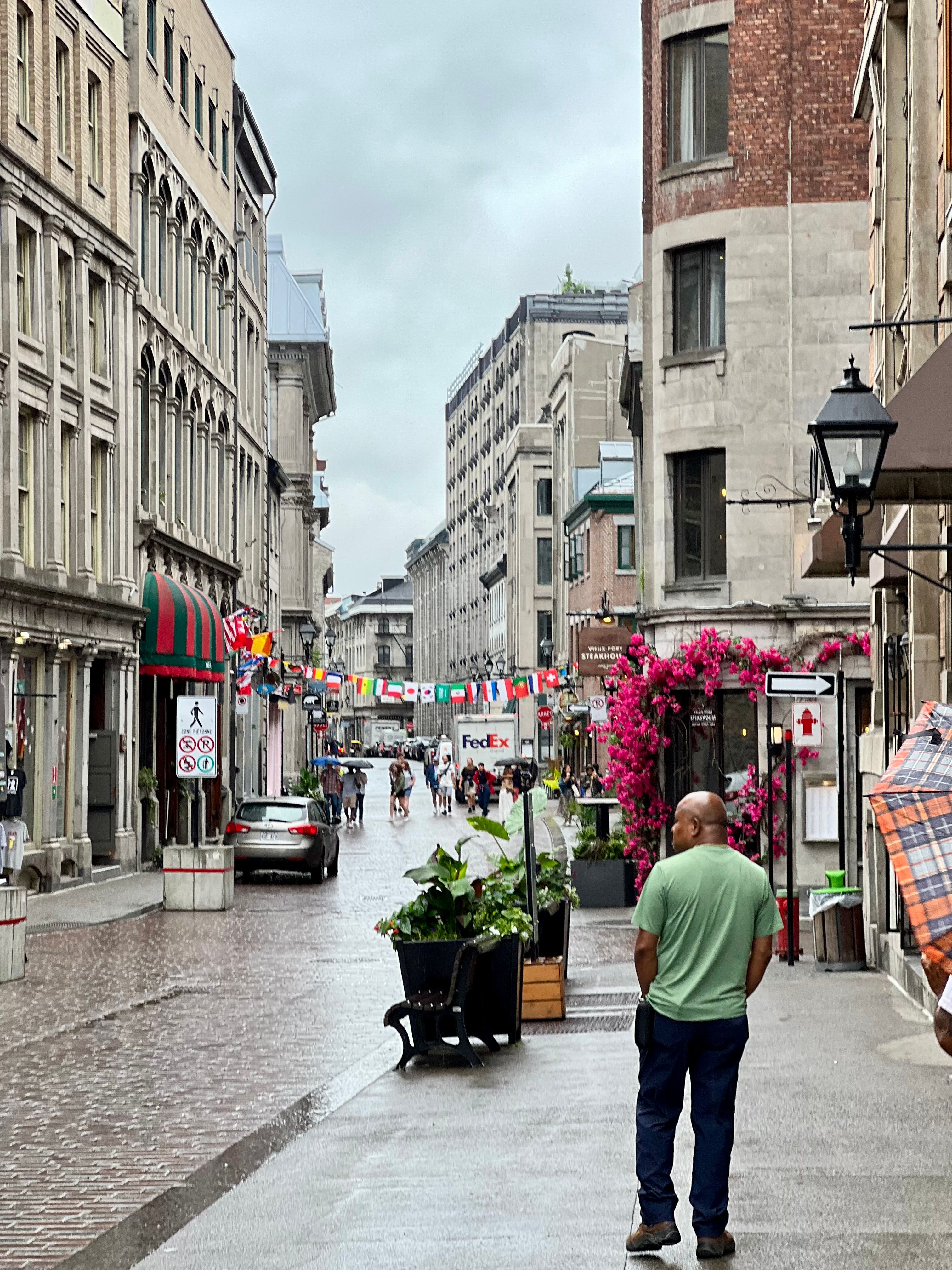 Charming Urban Street with Flags and Flowers · Free Stock Photo