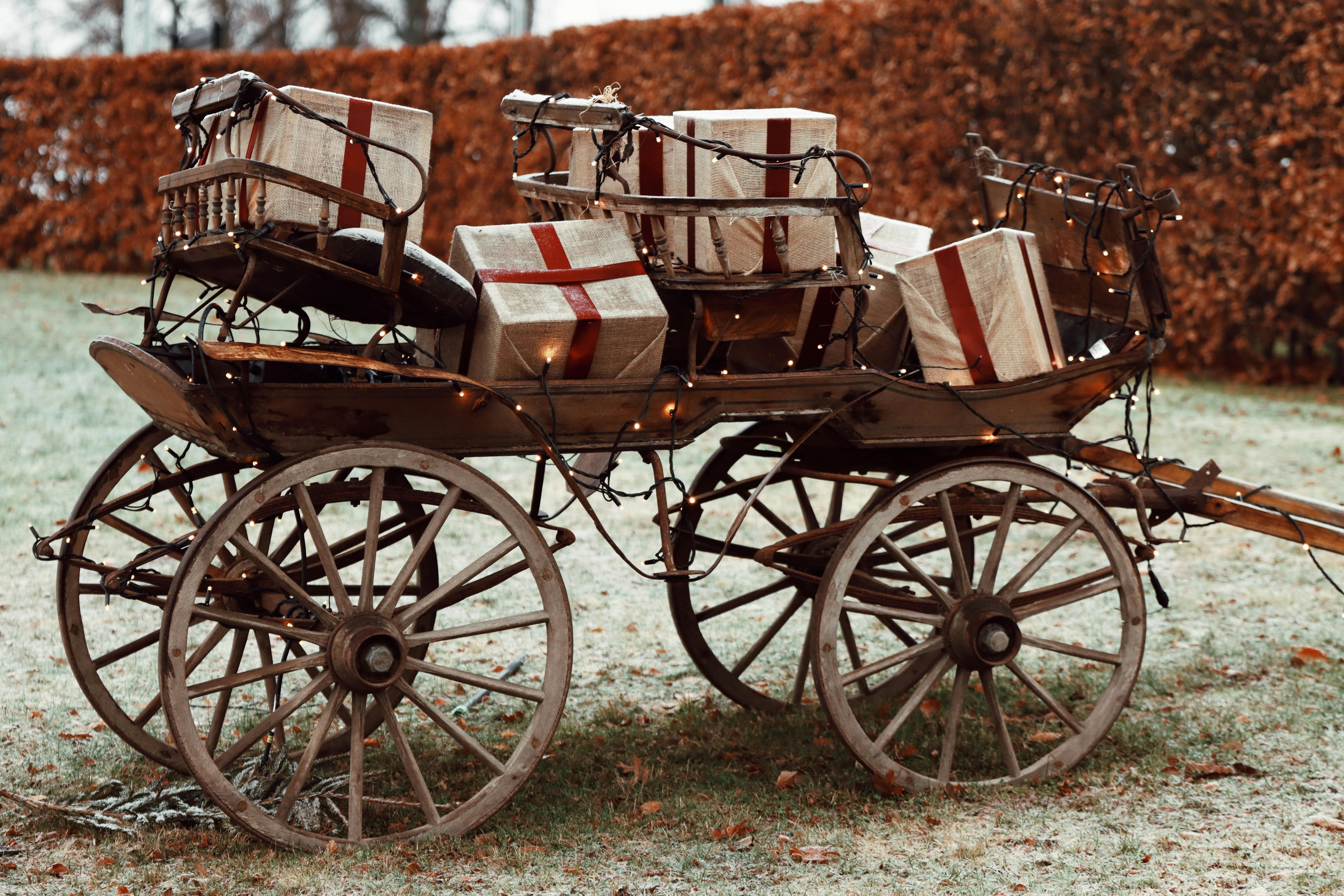 festive wooden cart with christmas gifts outdoors