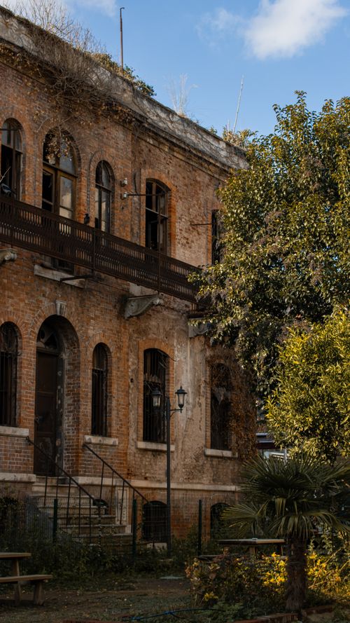 Free Explore the beauty of an old historic building in İstanbul surrounded by lush autumn foliage. Stock Photo