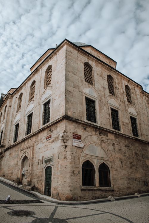 Free Low angle view of a historic mosque showcasing intricate architecture and unique perspective, ideal for urban exploration. Stock Photo