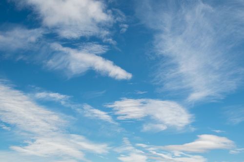 Free A serene blue sky filled with light, wispy clouds, perfect for nature themes. Stock Photo