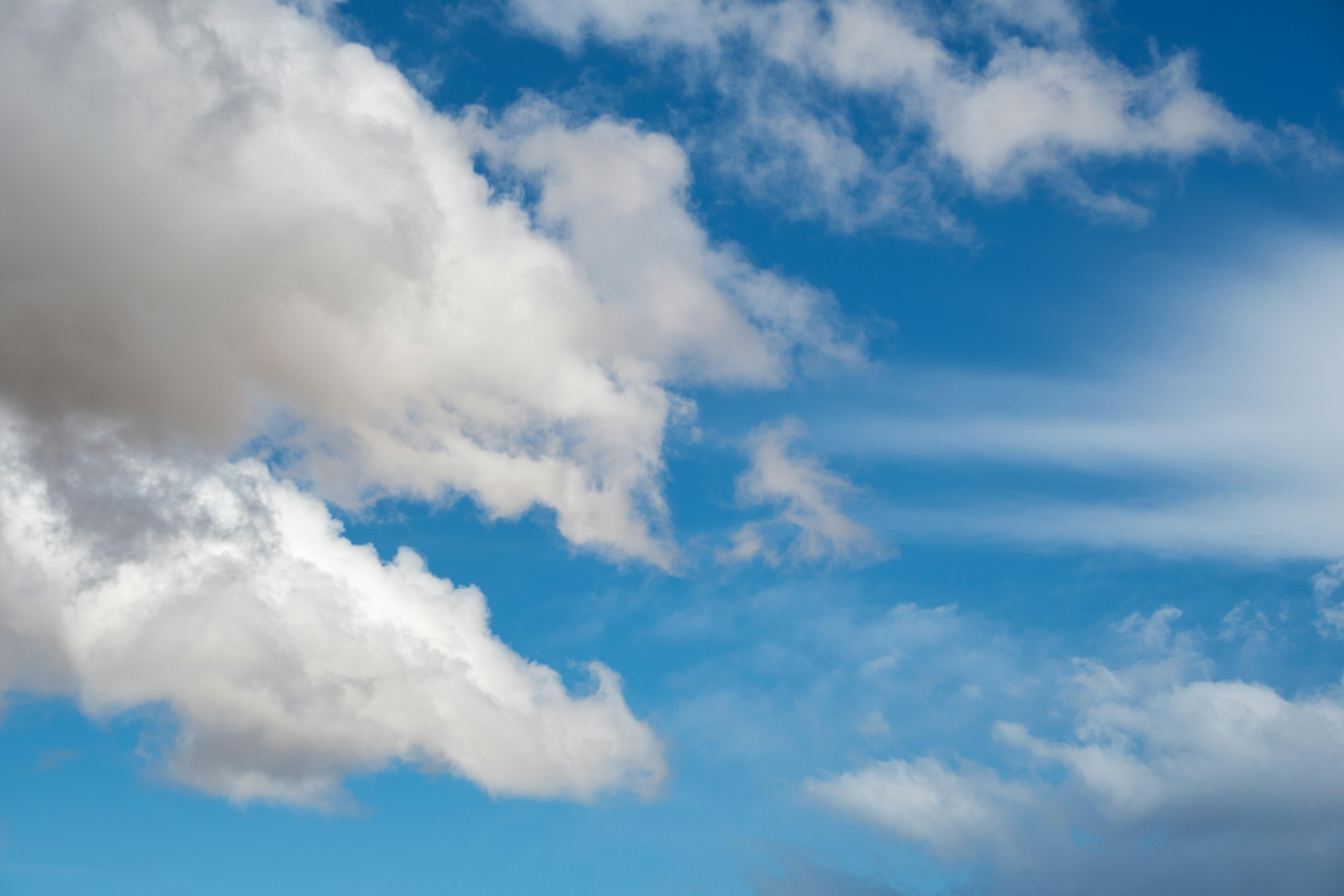 fluffy white clouds against blue sky