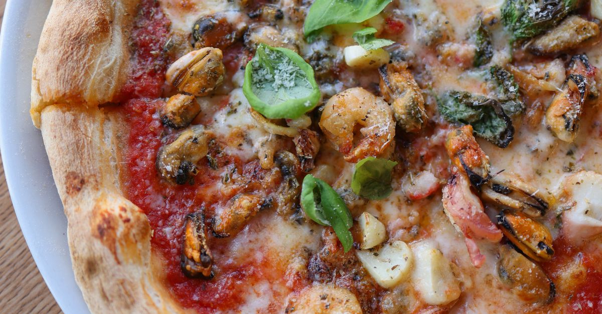 Gourmet Seafood Pizza with Fresh Basil · Free Stock Photo
