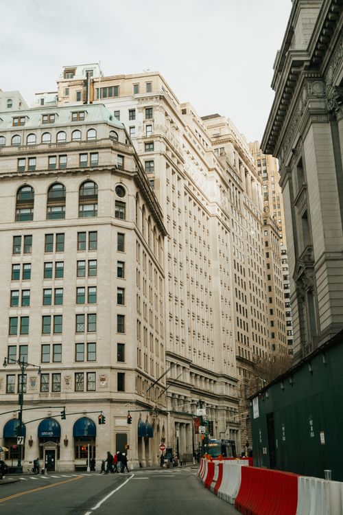 Free City street with tall historic buildings under a cloudy sky captured in daylight. Stock Photo