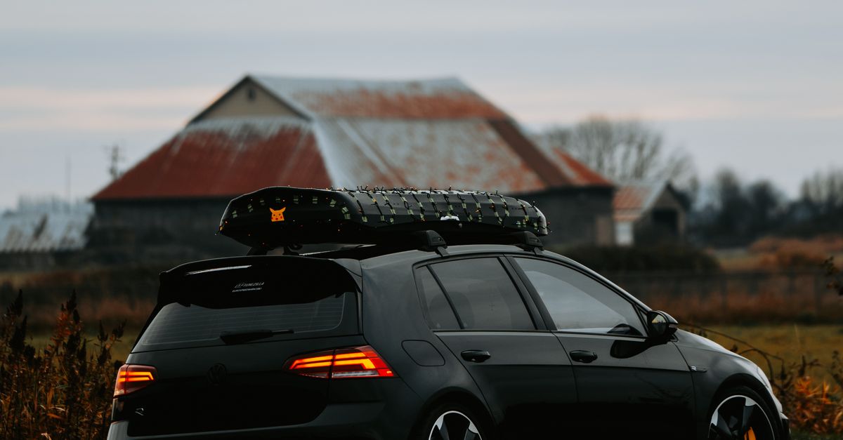 Car In Rural Setting Sleek Car Parked in Rural Countryside at Dusk · Free Stock Photo