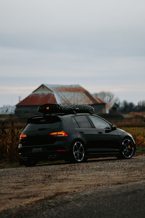 Car In Rural Setting Sleek Car Parked in Rural Countryside at Dusk · Free Stock Photo