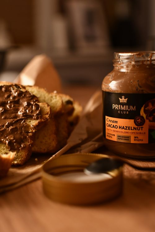 Free Delicious hazelnut cacao spread on freshly baked rustic bread. Perfect breakfast setting. Stock Photo