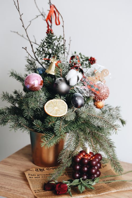 Free Christmas arrangement with pine, ornaments, and dried citrus for holiday decor. Stock Photo