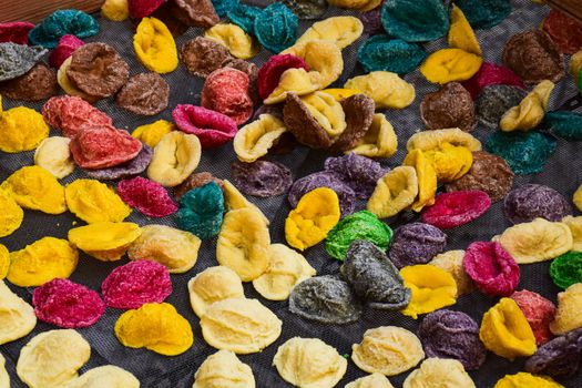 A vibrant assortment of homemade colorful orecchiette pasta drying in Apulia, Italy.