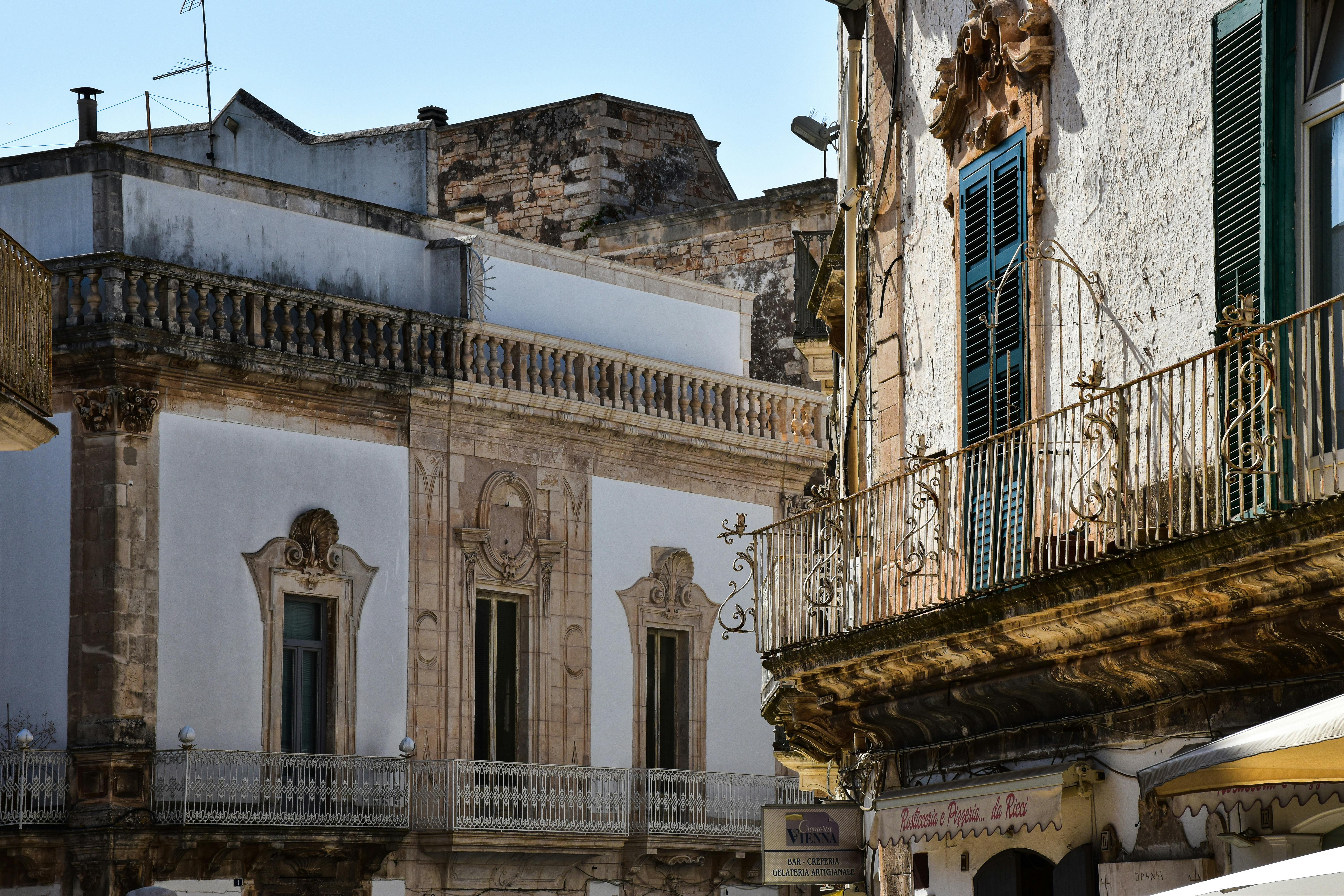 Charming view of historic Italian architecture in Apulia, showcasing detailed facades and rustic charm.