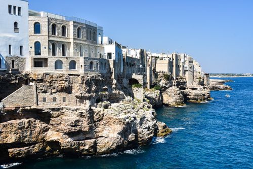 Free Breathtaking view of Polignano a Mare's historic cliffs and azure sea in Apulia, Italy. Stock Photo