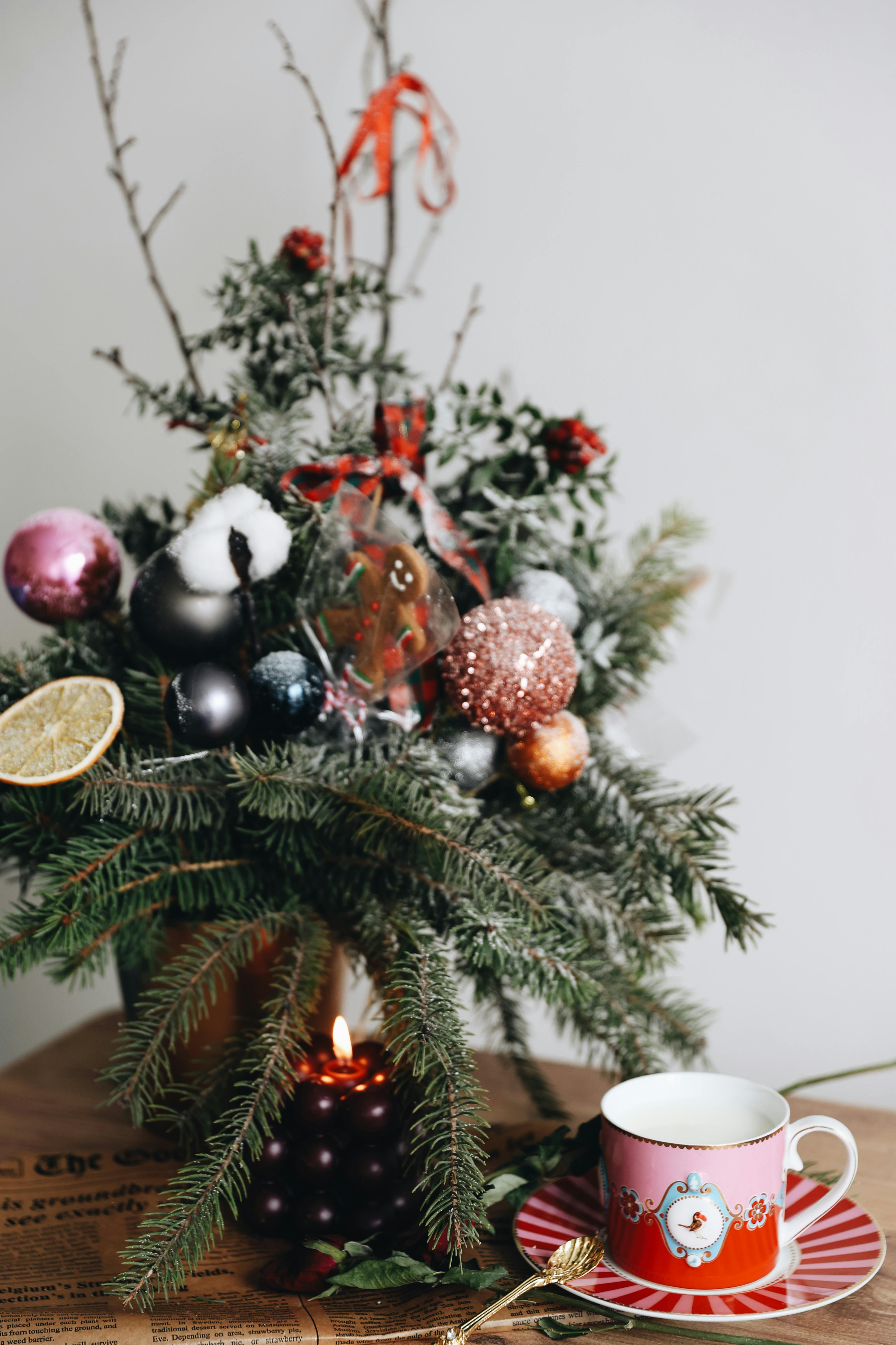 festive christmas arrangement with candle and tea