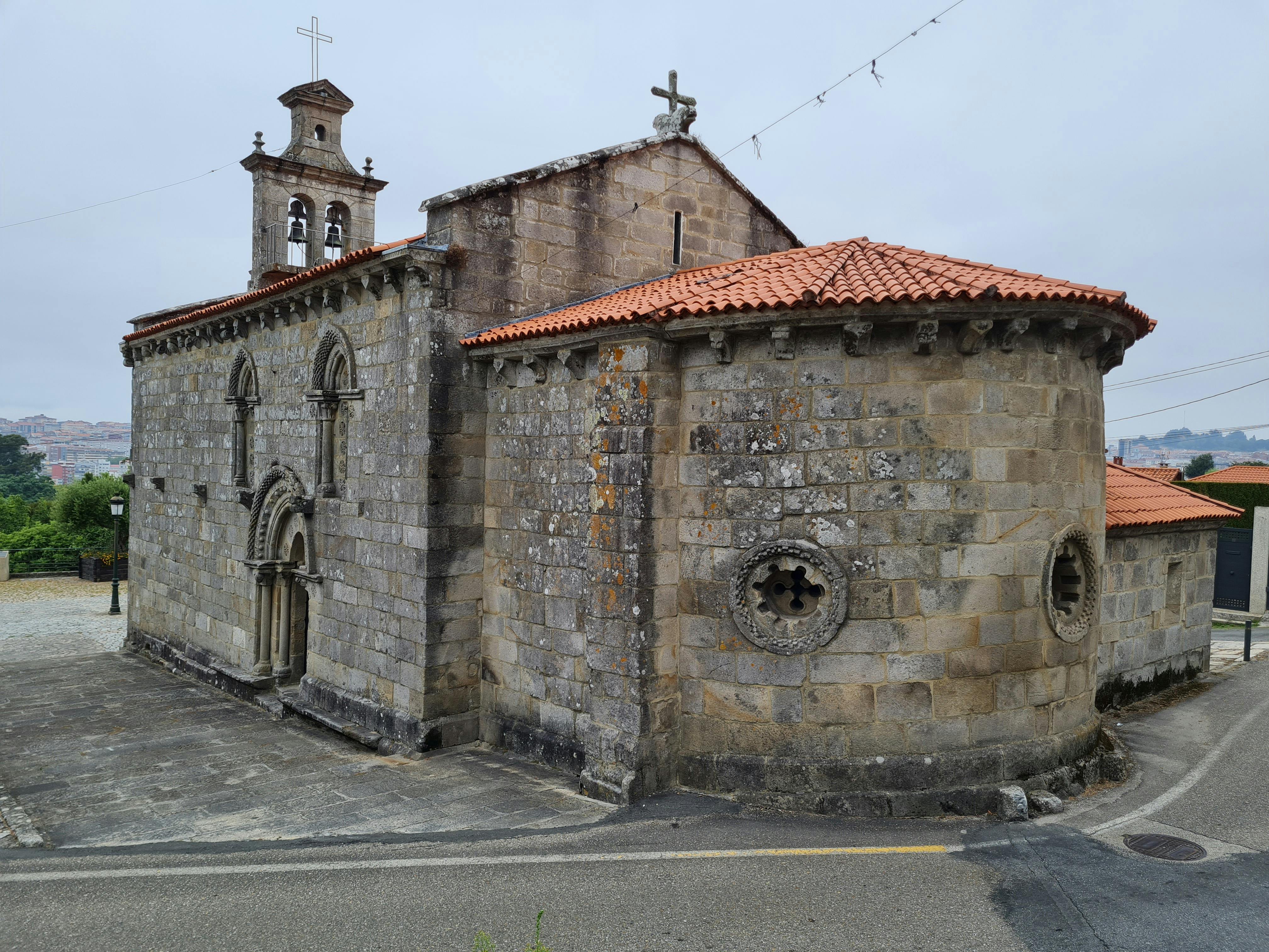 historic stone church with red tiled roof